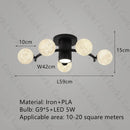 designer ceiling light in black and gold metal with white ball for modern interiors