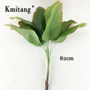 Large artificial monstera and banana plants for indoor decoration