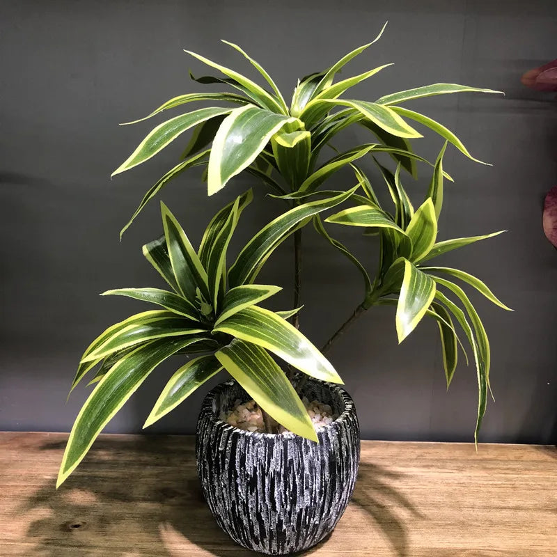 Artificial tropical plant with three heads in a decorative pot