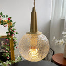 Gold glass pendant light with elegant copper design
