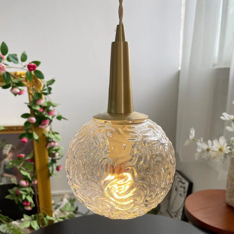 Gold glass pendant light with elegant copper design