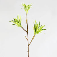 Large artificial bamboo branch with decorative flowers and leaves