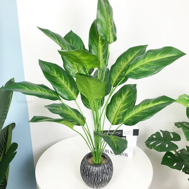 Artificial strelitzia and monstera plants for tropical decor