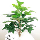 Artificial monstera and palm tropical leaves for indoor decoration