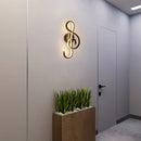 LED wall light in music clef shape