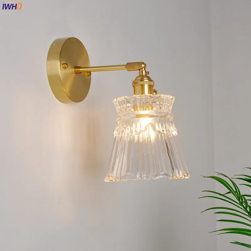 Gold wall light with glass lampshade