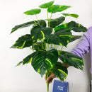 Artificial monstera and palm tropical leaves for indoor decoration