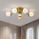 designer ceiling light in black and gold metal with white ball for modern interiors