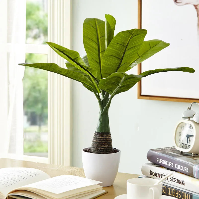 Artificial monstera palm tree in pot for indoor decor