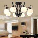 Vintage wrought iron ceiling light with elegant glass shade