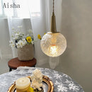 Gold glass pendant light with elegant copper design