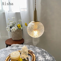 Gold glass pendant light with elegant copper design