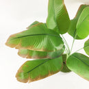 Large artificial monstera and banana plants for indoor decoration