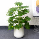 Artificial tropical monstera and palm palm plants in plastic for decoration