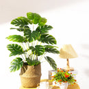 Artificial tropical tree with large decorative monstera leaves
