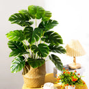 Artificial tropical tree with large decorative monstera leaves