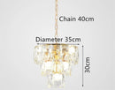 Round gold steel chandelier with crystal and interior LED lighting