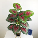 Artificial monstera and palm tropical leaves for indoor decoration
