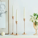 Set of three gold brass candle holders for weddings and dinners