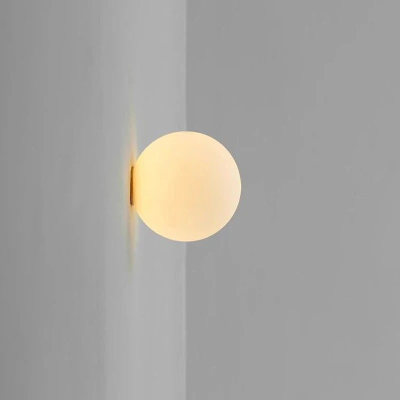 Modern glass globe lamp with concealed base for versatile use