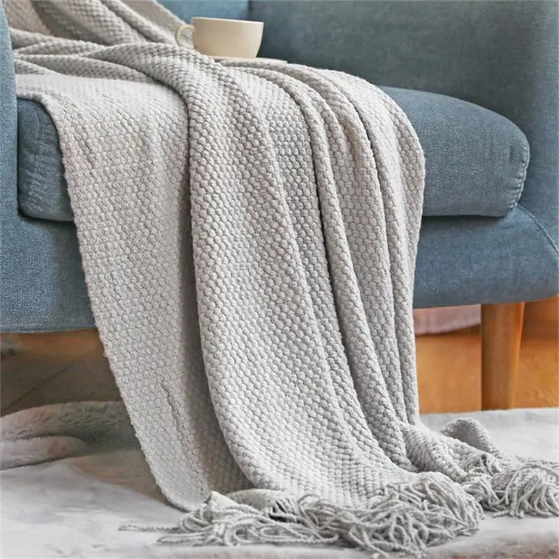 Nordic checked knitted throw with soft pompoms