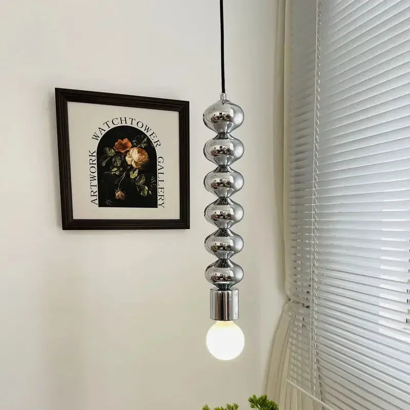 Modern industrial chrome bedside lamp with long wavy line