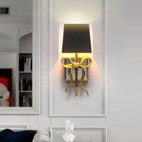 Bow shaped brass wall light for children's bedroom