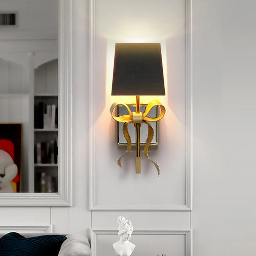 Bow shaped brass wall light for children's bedroom