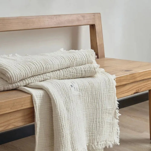 Lightweight cotton muslin throw with tassels for sofa