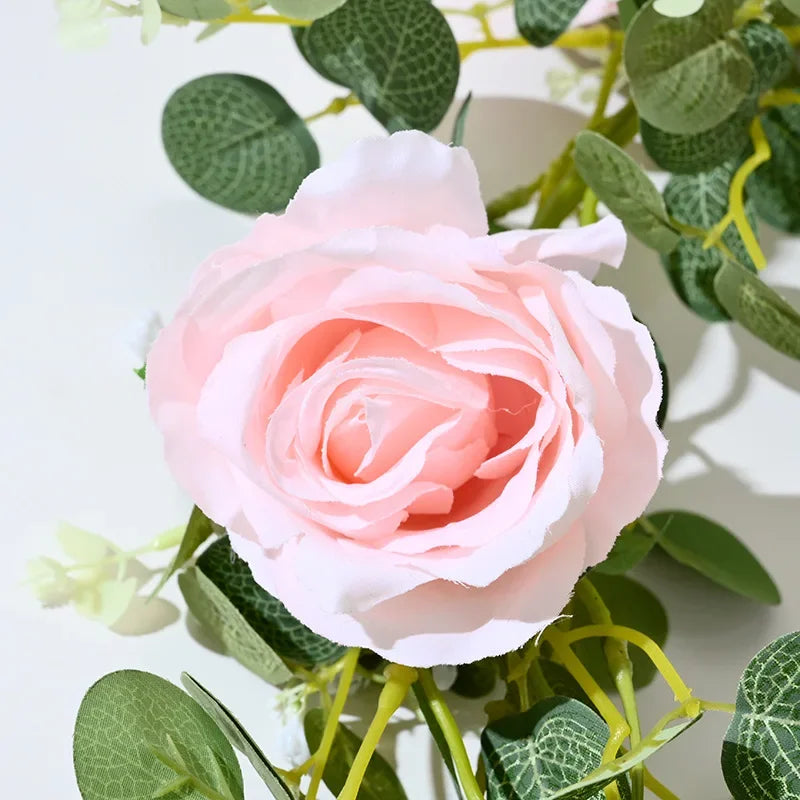 Artificial pink flowers and green plants for indoor decoration