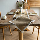 Beige jute-effect table runner with tassels, rustic style