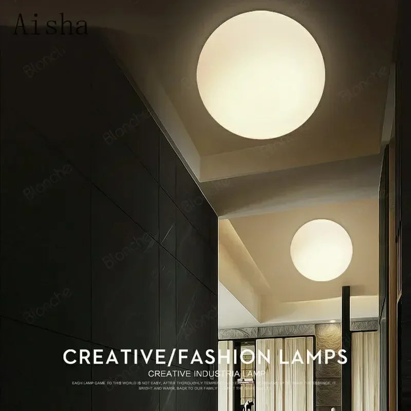 Modern LED wall light with round white glass shade