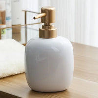 ceramic soap dispenser with gold pump for bathroom