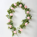 Artificial pink flowers and green plants for indoor decoration