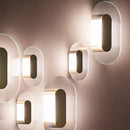 Elliptical glass and gold metal wall light