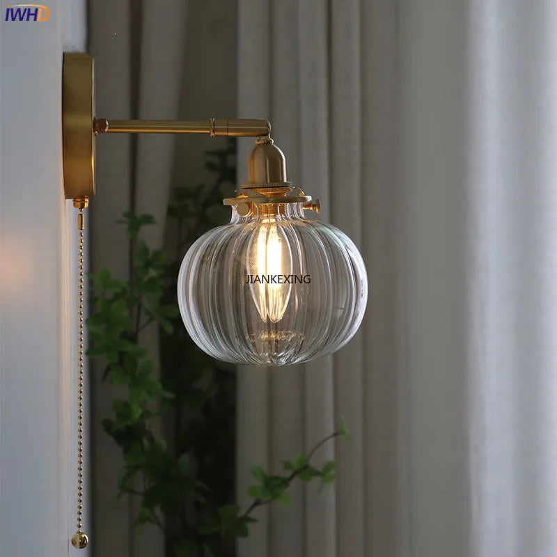 Modern wall light with pull chain and glass globe