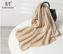 Pure cashmere knitted scarf with elegant winter pompoms