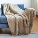 Knitted throw with pom-poms and chequered pattern nordic style