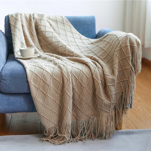 Knitted throw with pom-poms and chequered pattern nordic style