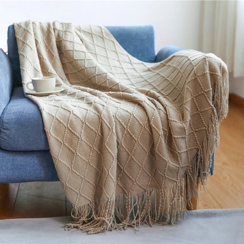Knitted throw with pom-poms and chequered pattern nordic style