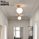 Round glass and Japanese walnut wood pendant light
