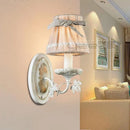 Iron wall light with fabric lampshade and ribbon bow