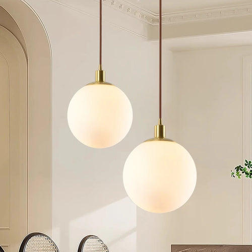 Minimalist brass pendant light with milky glass orb - vue 2 sur 9