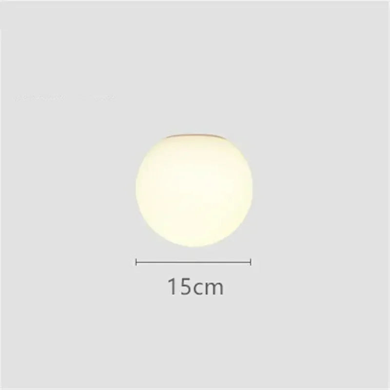 Modern LED wall light with round white glass shade