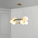 Gold round LED chandelier with glass globes