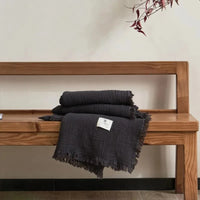 Lightweight cotton muslin throw with decorative tassels for living room