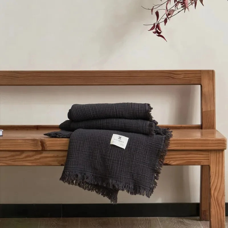 Lightweight cotton muslin throw with decorative tassels for living room