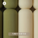 handcrafted scented candles with striped columns and wind chimes