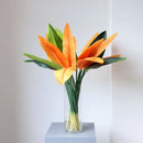 Tropical floral arrangement with decorative birds and bananas for weddings