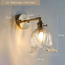 Modern adjustable glass and brass wall light for an elegant interior